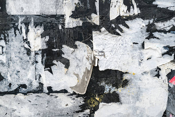 istock Grunge texture of torn paper layers and worn posters on old wall with rough surface. 2243419938
