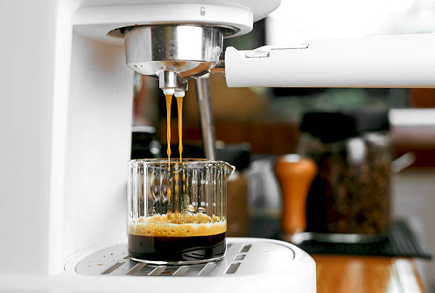 Pouring coffee into the coffee cup close up.Automatic coffee machine.
