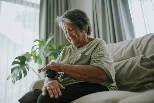 istock Elderly massaging her forearm with a spiky massage ball. 2243422495