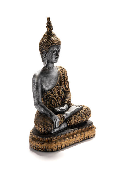 istock Meditating Buddha Statue With Ornate Robe Sits in Peaceful Pose on Decorative Base 2243424519