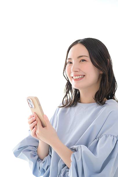 A Japanese woman who looks at her smartphone and thinks