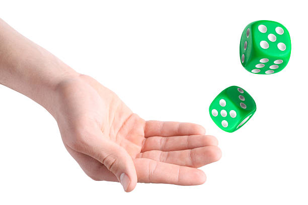 istock Man throwing green dice on white background, closeup 2243429251