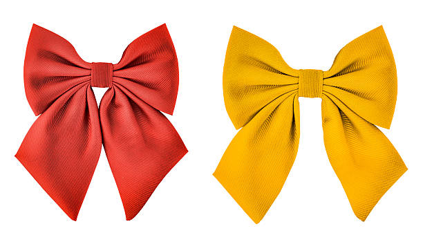 Two elegant decorative bows in bright red and golden yellow, isolated on white background. Both ribbons feature soft fabric texture with subtle folds and shadows, ideal for holiday decor, gift wrapping, party embellishments, and craft projects. Perfect image for Christmas, New Year, birthday, or festive packaging concepts.