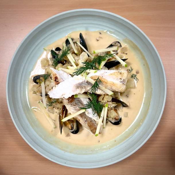 istock seafood stew on white sauce and julienne apples 2243437523