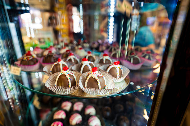 Candy and other sugary sweets on display in glass case.