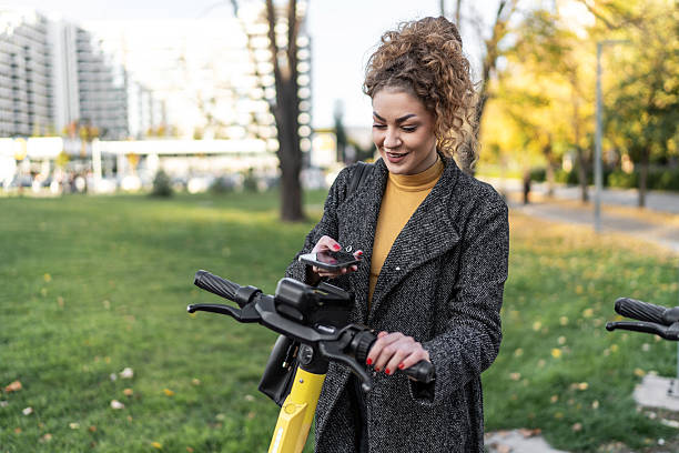 istock Woman renting e-scooter with smartphone application in park 2243444996