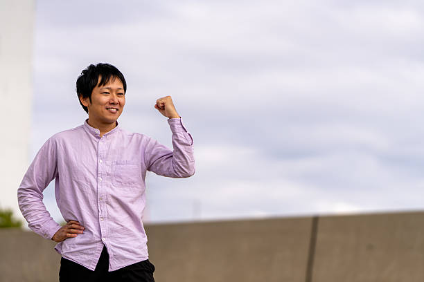 istock Smiling Man Celebrating Success with a Fist Pump (Ample Copy Space) 2243445162