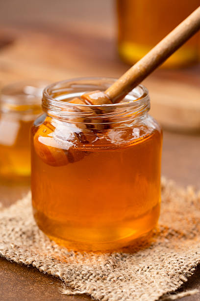 istock Honey jar and honey dipper on vintage background 2243445791