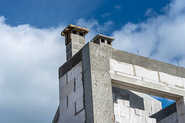 istock The gable walls are poured with concrete, with visible system chimneys. 2243447218