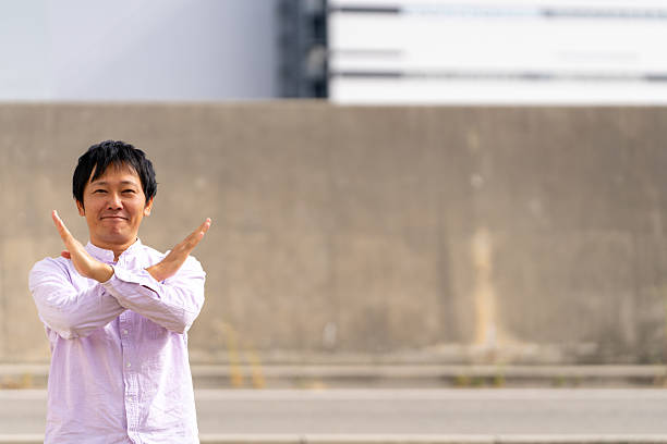 Man Making an “X” Gesture with Arms | Clear NO Message