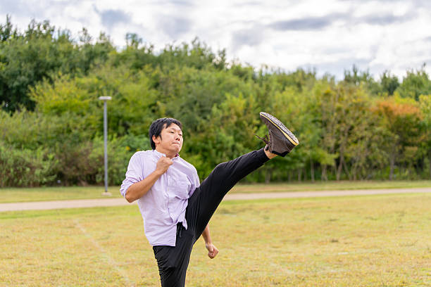 Man Performing a High-Leg Stretch | Dynamic Warm-up Outdoors