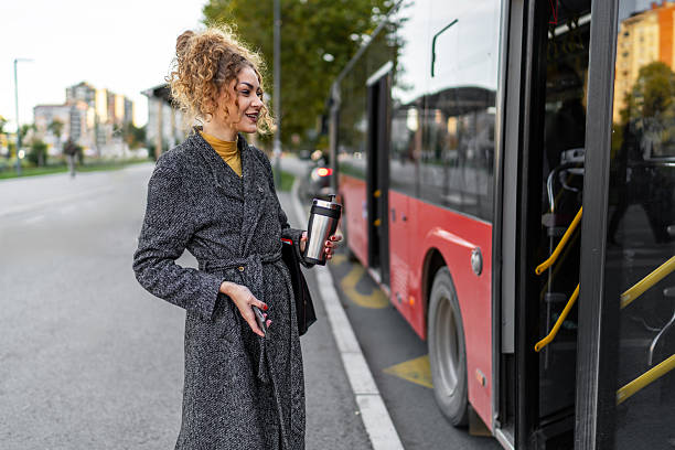 istock Woman commuting by bus with reusable coffee cup 2243454928