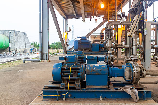 Industrial pumps and motors in an old facility showcase engineering and maintenance.