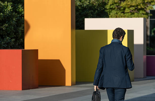 front, side and  back view of the same man walking with a jacket