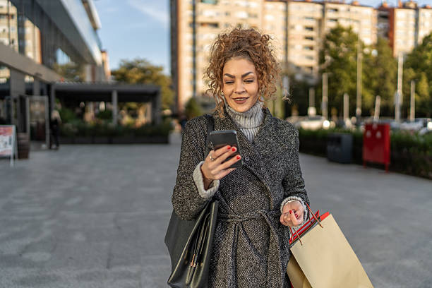 istock Woman walking, shopping, using phone in city 2243455799