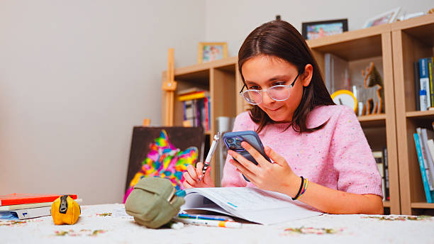 istock Preteen Girl  at Desk Solving Homework with AI Chatbot 2243455897