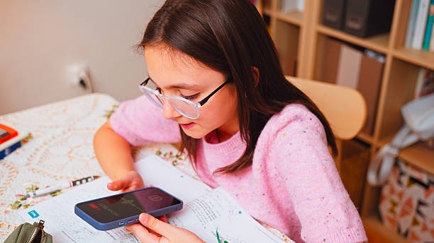 istock Preteen Girl  at Desk Solving Homework with AI Chatbot 2243455943