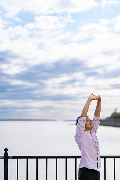 Man Stretching with the Ocean Behind | A Moment to Unwind