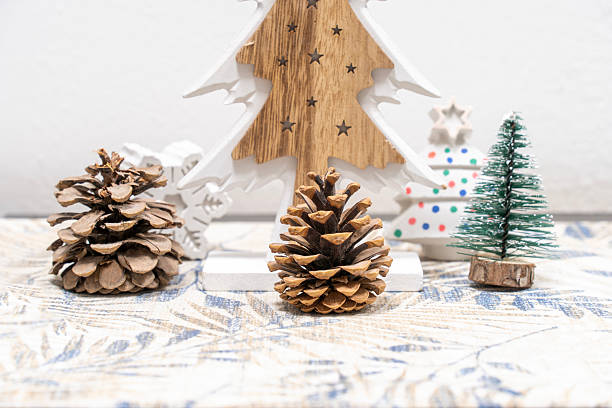 istock Rustic Christmas decoration with pine cones and trees on white background 2243457682