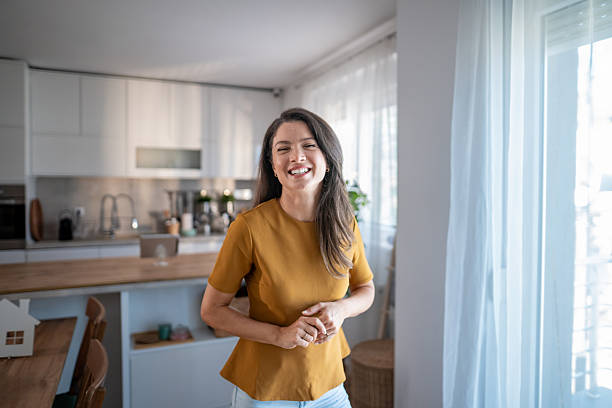 istock Happy woman smiling to camera in kitchen 2243458303