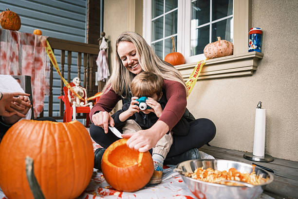 istock Single mother and her toddler son carving pumpkins 2243458461