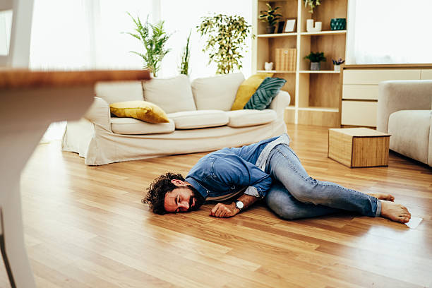istock Man having an epileptic seizure falling on living room floor 2243458496