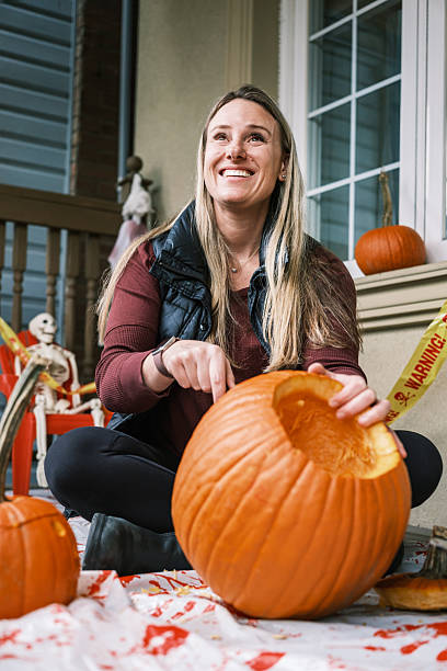 istock Single mother carving pumpkin for Halloween 2243458709