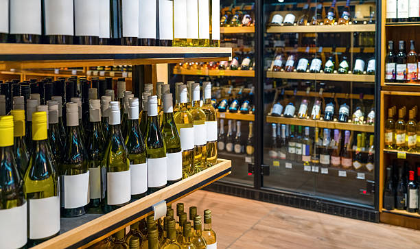 istock Wine retail sector with wine bottles on display in liquor store. 2243460017