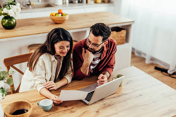 istock Couple planning home finances together using laptop 2243460397