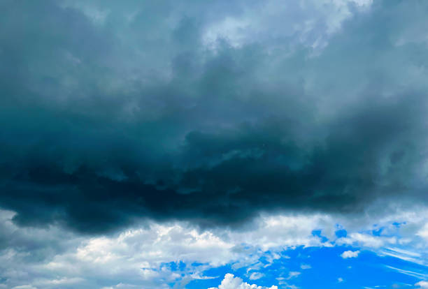 Dark clouds roll in, contrasting with the vibrant blue sky, indicating a shift in weather as evening approaches.