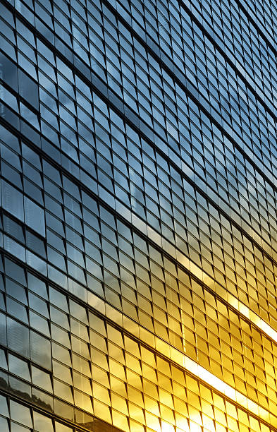 istock Glass building facade reflecting golden sunset light 2243464153