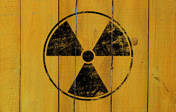 istock Radioactive warning symbol on distressed yellow wood 2243464211