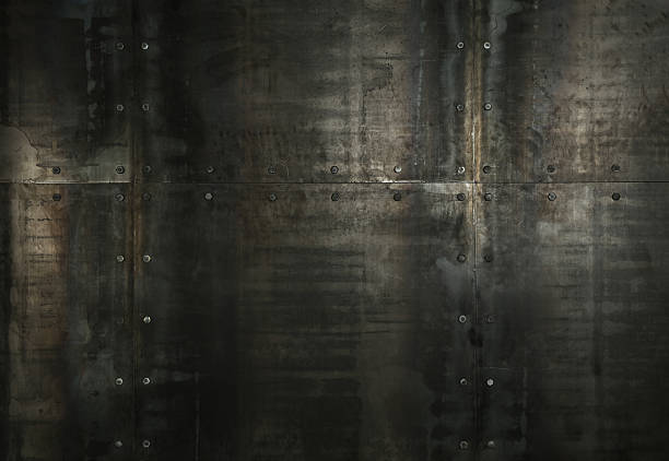 Riveted steel plates forming a weathered, distressed industrial wall — dark grungy metallic texture with scratches, rust and bolted seams, full-frame rugged background