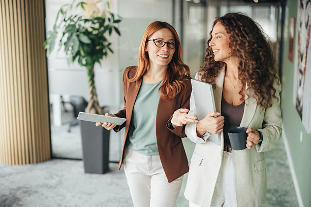 istock Confident female professionals talking on the go 2243467155