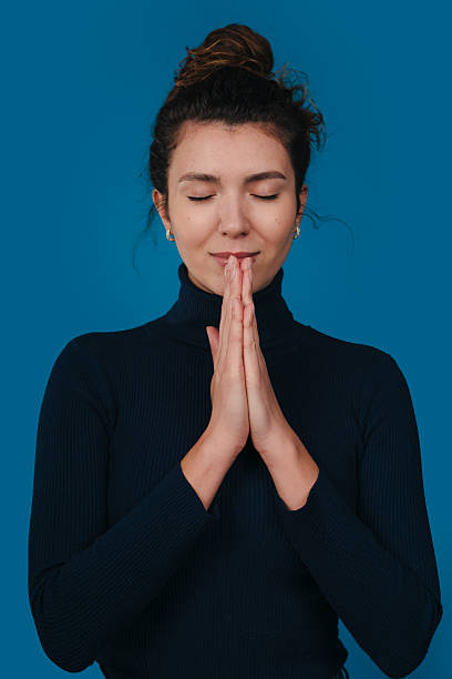istock A woman practices mindfulness with her hands together in a serene pose, embodying awareness 2243469607
