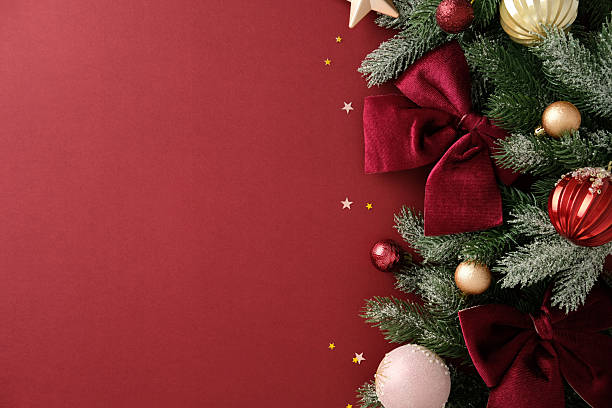 istock Right-side Christmas composition with pine branches, velvet bows, and ornaments on red background. Xmas banner mockup, vintage postcard template 2243469967