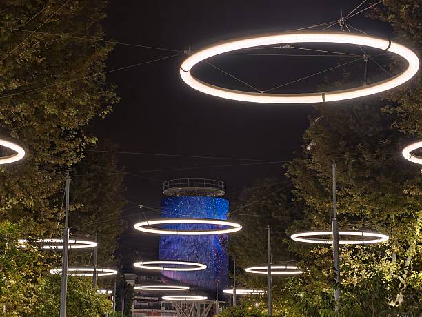 nighttime luminous walkway, suspended circular lights craft inviting night park pathway ambiance