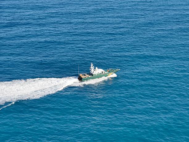 istock Highspeed patrol craft navigating azure waters with crew onboard 2243472582