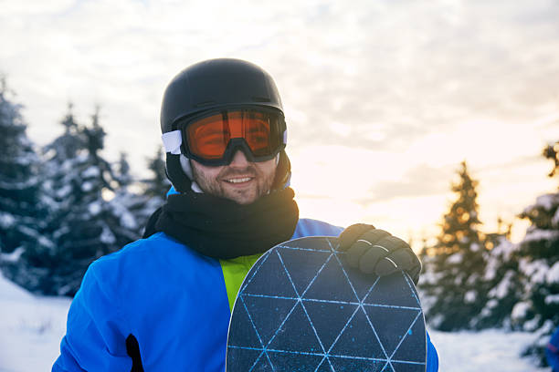 istock Smiling Snowboarder Poses Outdoors in Winter Mountain Landscape. 2243472702