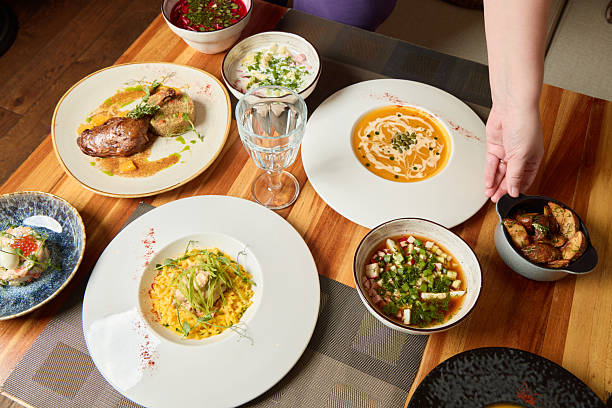 An inviting spread of diverse dishes artfully served on a wooden table, perfect for sharing with friends