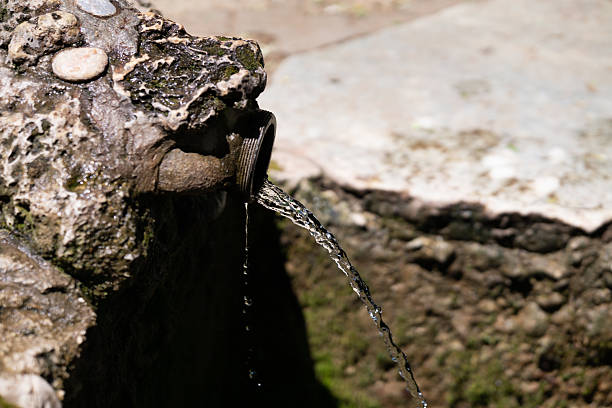 Pure spring water. Waterfall from the rock, cold and clear drinking water.