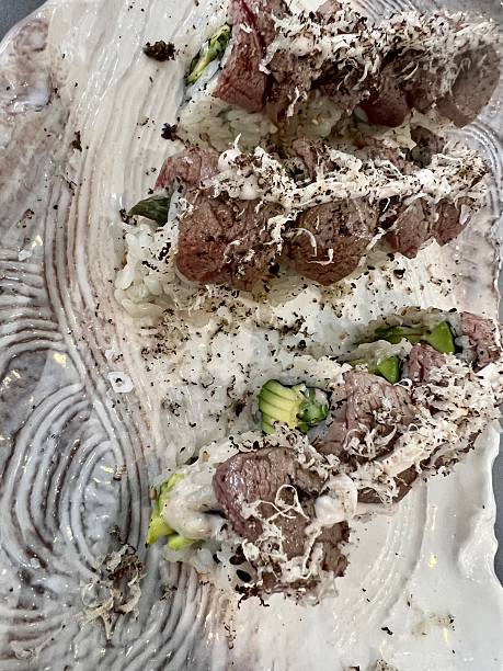 Gourmet sushi rolls with beef, avocado, truffle, and rice