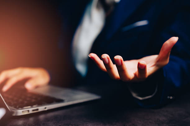 istock Business professional discussing ideas with hand gesture near laptop in modern office setting conveying engagement and communication 2243483965