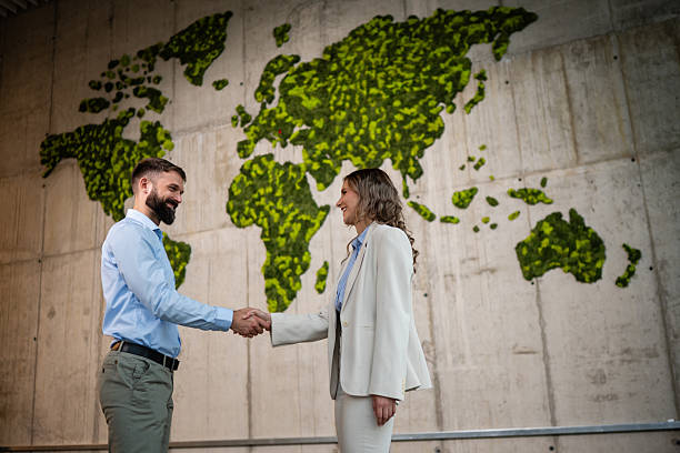 istock Business partners shaking hands global eco agreement 2243489338
