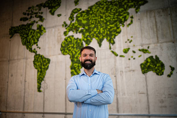istock Businessman standing in front of world map 2243489353
