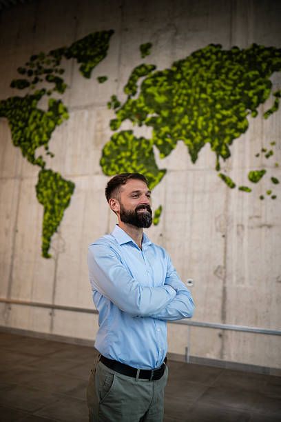 istock Entrepreneur standing in corporate office with world map 2243489389