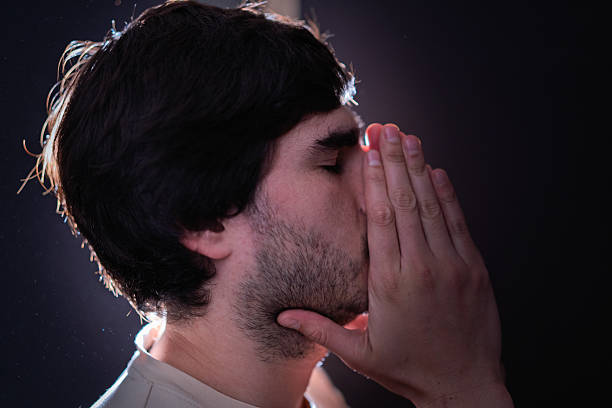 Teenager praying on his knees