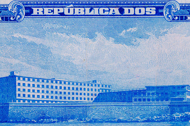 A blue and white engraved image shows multiple buildings and text on a textured background, resembling a postage stamp or currency.