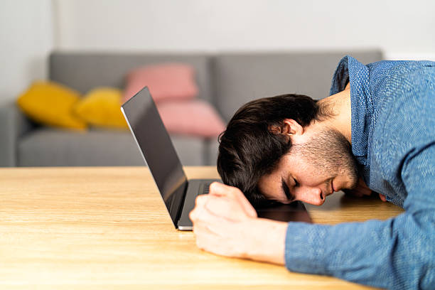 istock Young man experiencing burnout on laptop at home 2243490129