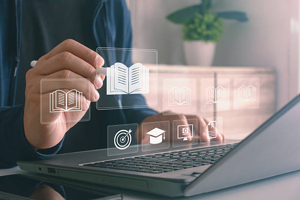 istock Digital education concept. Person using a stylus with virtual learning icons on a laptop screen, symbolizing e-learning, online courses, modern technology and knowledge sharing in digital classrooms. 2243490248